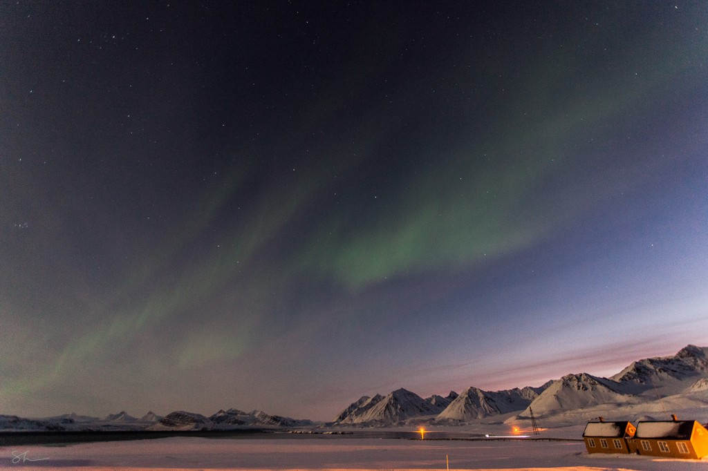 The Aurora Borealis serve as a light source in the skies over Ny Alesund.     